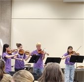 Teens playing stringed instruments.