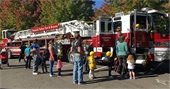 Families lined up by a fire truck.